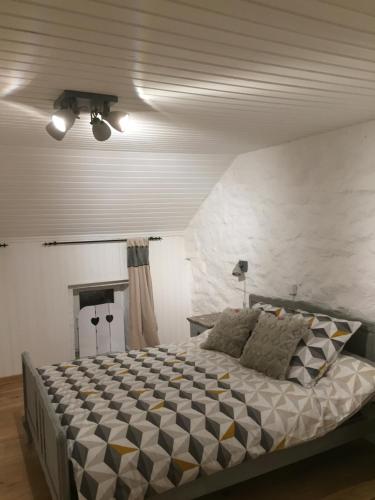 a bedroom with a large bed in a room at La Fermette du Lac in Spa