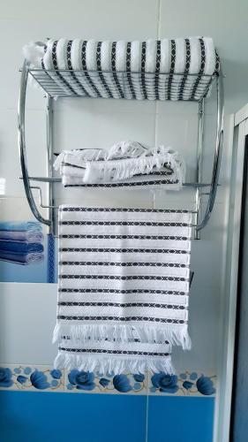 a stack of towels on a rack in a refrigerator at TANJITAN HOSPITALITE in Tangier