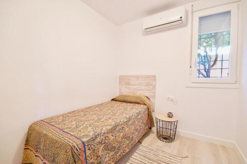Habitación blanca con cama y ventana en MalagaUrbanRooms - Beach & Sea, en Málaga