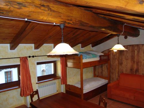 a bedroom with a bunk bed and two windows at Amemi 2 in Issogne