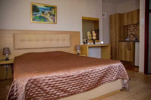 a bedroom with a bed with a brown blanket on it at Dimitra House in Stavros