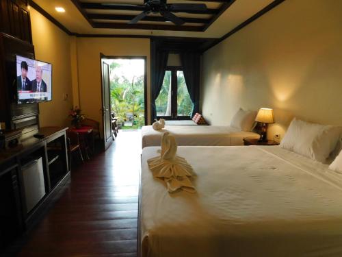 Łóżko lub łóżka w pokoju w obiekcie Sengahloune Resort