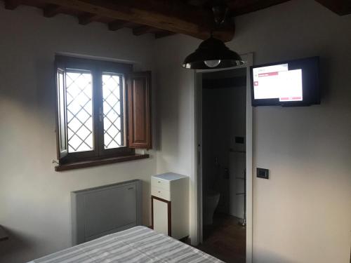 a bedroom with a bed and a window at Bellavista Prile in Castiglione della Pescaia