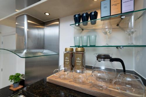 a bunch of wine glasses sitting on a counter at Huge & Central 3 Bedr, 4 Beds, 2,5 Bath Covent Gdn in London