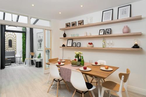 a dining room and living room with a table and chairs at Huge & Central 3 Bedr, 4 Beds, 2,5 Bath Covent Gdn in London