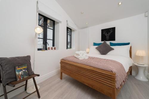 a bedroom with a large bed and a chair at Huge & Central 3 Bedr, 4 Beds, 2,5 Bath Covent Gdn in London