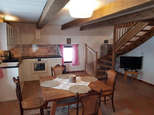 a kitchen and dining room with a table and chairs at Apartmán Malšín in Malšín