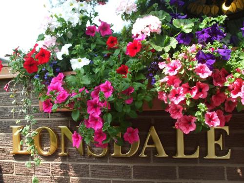 a sign with flowers on a brick wall at The Lonsdale in Blackpool