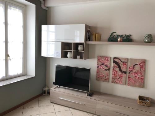a living room with a flat screen tv on a wall at AcquaTerraFuoco - City apartments in Como