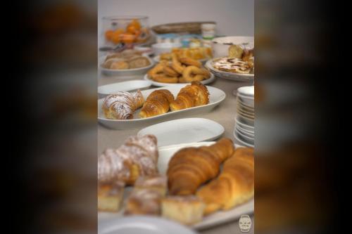 a table filled with different types of pastries and croissants at Ca' Du Ale in Sestri Levante