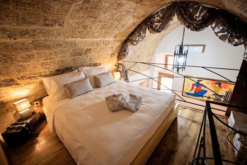 a bedroom with a large bed in a brick wall at Athina house in Rhodes Town