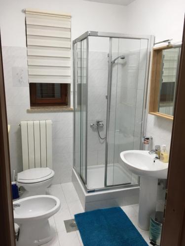 a bathroom with a shower and a toilet and a sink at Nela Apartment in Rabac