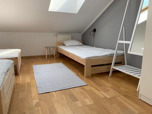 a bedroom with two beds and a ladder at Apartament Bielik in Mrągowo