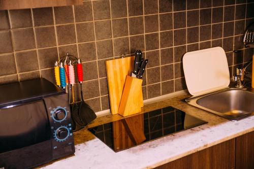 a kitchen counter with a sink and a microwave at Kantar Hotel in Yerevan