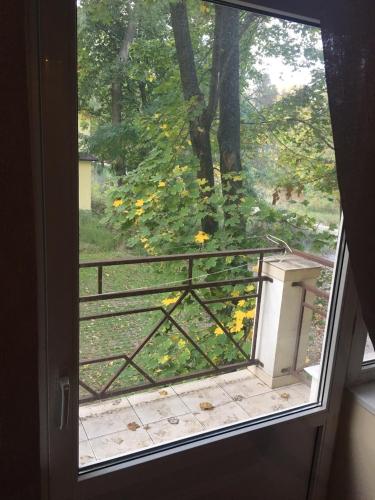 an open door with a view of a garden through a window at Гостевой дом писателей in Odesa