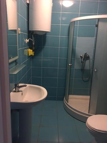 a bathroom with a sink and a shower at Гостевой дом писателей in Odesa