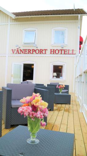 a vase of flowers on a table in front of a hotel at Vänerport Lakefront Hotell in Mariestad