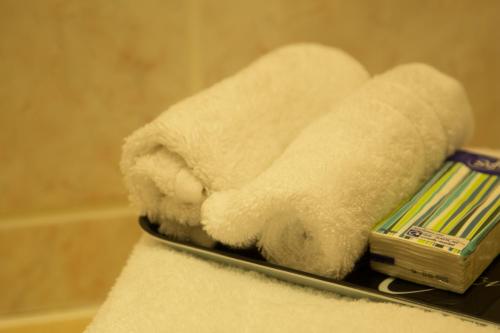 a pile of towels on a shelf in a bathroom at Station House Bed & Breakfast in Ennistymon
