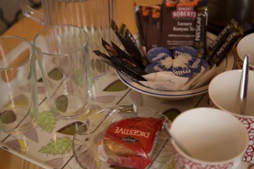 a table topped with glasses and a bowl of food at Station House Bed & Breakfast in Ennistymon