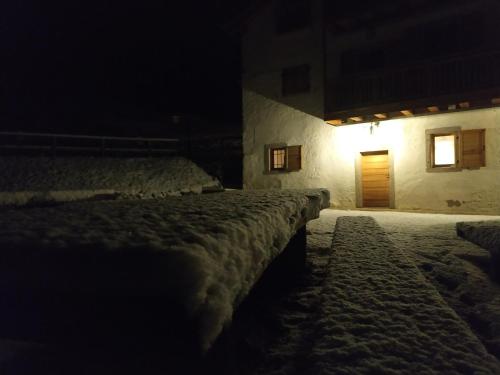 a room with a bed with snow on it at night at Limarò B&B in Sarche di Calavino