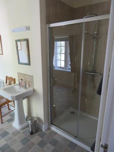 a bathroom with a shower and a sink at Balvraid Lodge B&B in Inverness