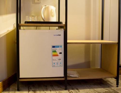 a small refrigerator in a kitchen with a shelf at Hot Budget Ortakoy in Istanbul