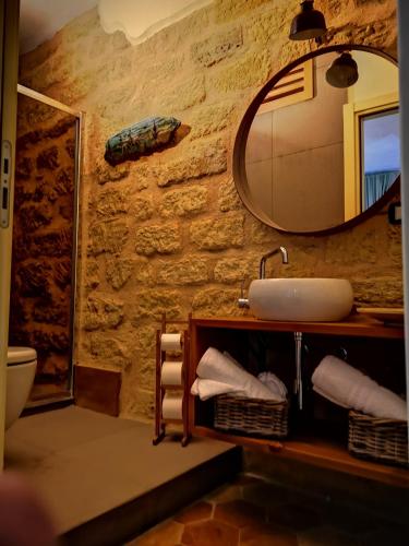 a bathroom with a sink and a mirror at Aljama - Downtown B&B in Agrigento
