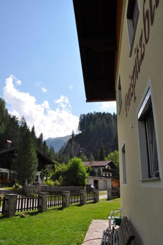 a building with a view of a yard with a fence at Haus Freispitzblick in Bach