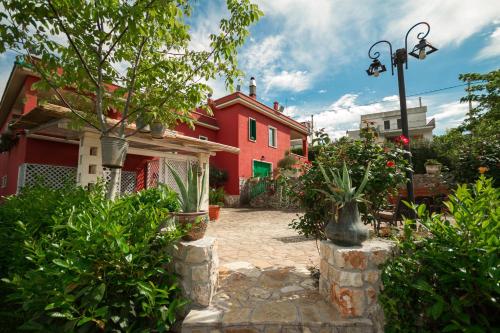 a red house with plants in front of it at Villa Giacomina in Fasano