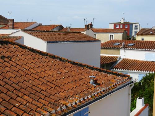 a group of roofs with red tile roofs at Hôtel Les Embruns Sables d'Olonne in Les Sables-dʼOlonne