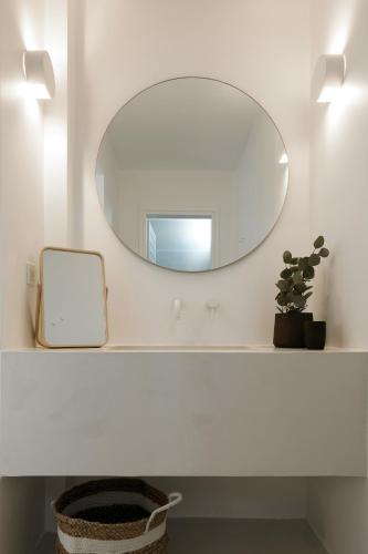 a bathroom with a mirror and a sink at Le Blanc Nest Santorini - Family / Couples Luxury House in Mesaria