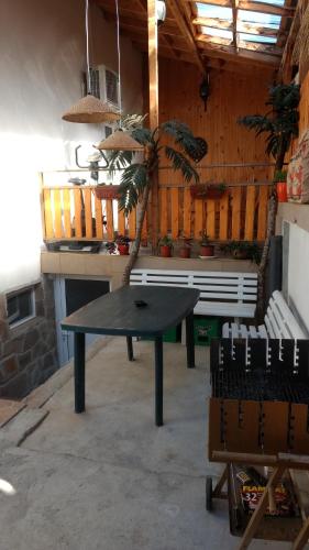 a black table in a room with a bench at Къща за гости с минерална вода "Терма Асклепий" in Kyustendil