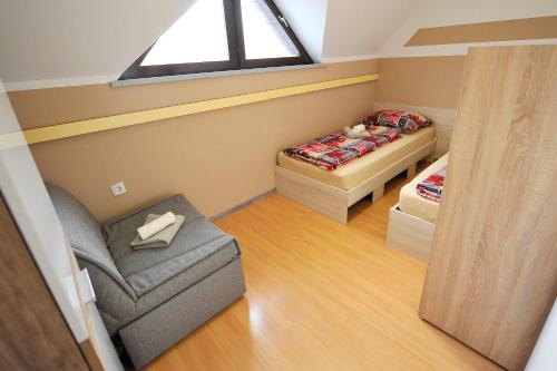 a small room with a bed and a chair at Aparthouse SUPREME with Terme Catez Swimming Pools Tickets in Čatež ob Savi