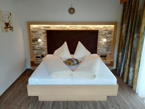 a bedroom with a bed with two pillows at Apart Almrausch in Nauders