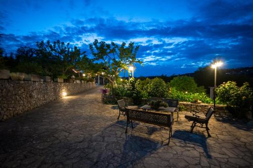 a patio with a table and chairs at night at Villa Giacomina in Fasano