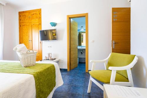 a room with a bed and a chair and a mirror at Elcano in Málaga