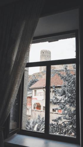 a window with a view of a castle at HOTEL JULIA Akhaltsikhe in Akhaltsikhe