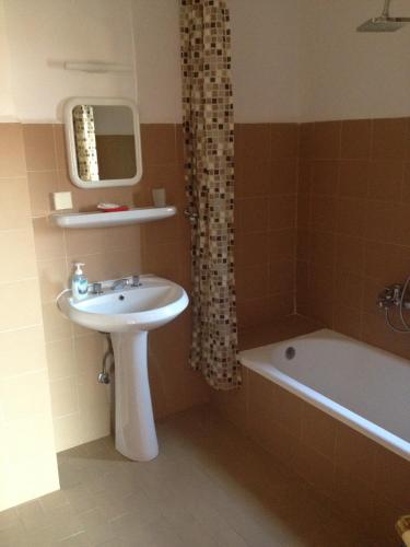 a bathroom with a sink and a bath tub at Kalkan Turk Evi in Kalkan