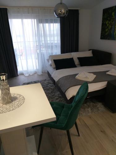 a bedroom with a bed and a table and chair at Luxury Apartments Mia in Podstrana