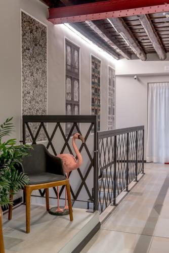 a pink flamingo chair on a balcony at APARTHOTEL CASA MIA in Milan
