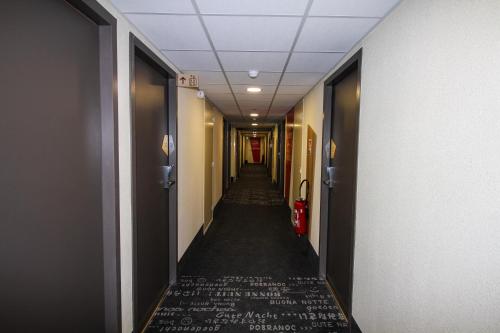 a hallway with a long corridor with a long aisle at B&B HOTEL Montélimar Sud in Montélimar