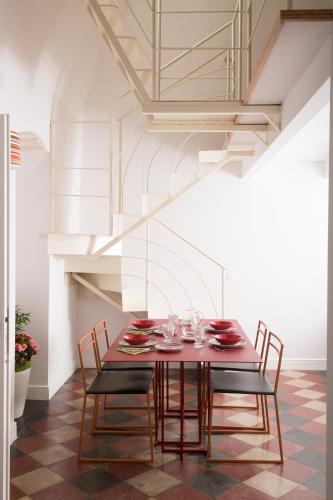a dining room with a red table and chairs at Dimora Cummà Marì in Vieste