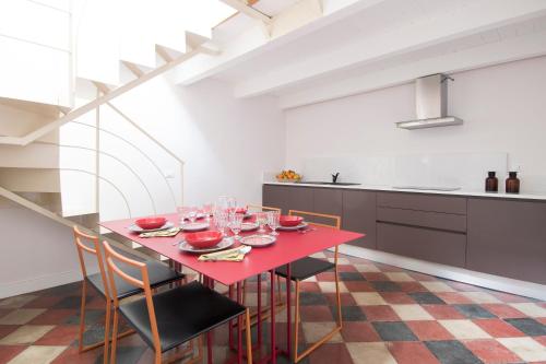 a dining room with a red table and chairs at Dimora Cummà Marì in Vieste