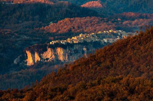 a mountain with a town on top of it at B&B Ad un passo dal Cielo in Pietrasecca