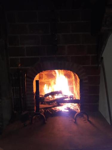 a brick oven with a fire in it at B&B Ad un passo dal Cielo in Pietrasecca