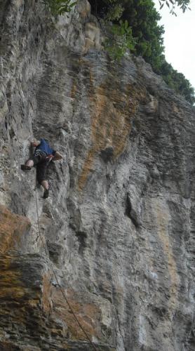 a man is climbing up a rocky mountain at B&B Ad un passo dal Cielo in Pietrasecca