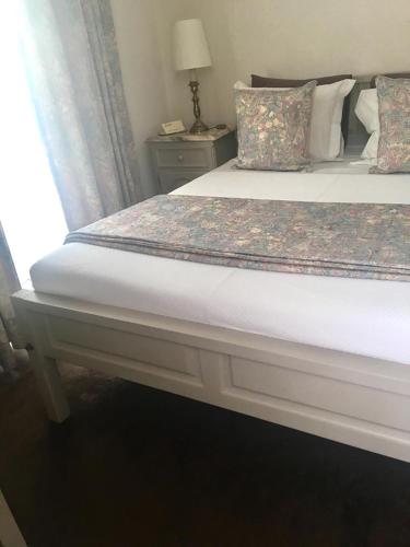 a bed in a bedroom with a window and a bedskirtspectspectspectspects at Hotel Central Jardim in Geres