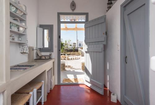 a hallway with a door leading to a patio at Aloni Studios in Ano Mera
