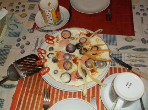 a plate of food with mushrooms and vegetables on a table at Vali Vendégház in Gyula