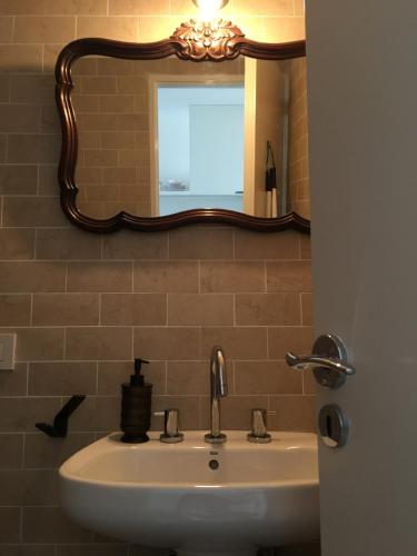 a bathroom with a sink and a mirror at Hipolito Estudio I in Belén de Escobar